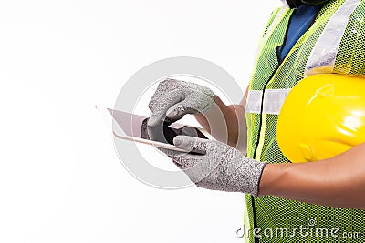 Engineer man working on digital tablet computer at worksite or industry. Handsome young industrial worker hold hard hat, safety Stock Photo