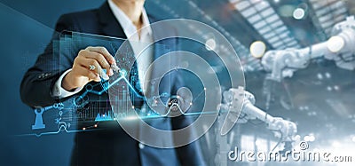 Engineer manager analyzing and control automation robot arms machine on software modern virtual interface data real time in Stock Photo