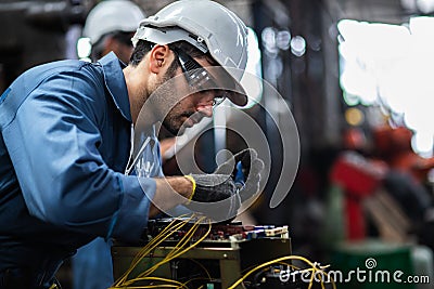 Engineer manual workers standing in a aluminum mill and working together Stock Photo
