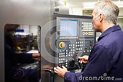 Engineer Operating Computer Controlled Lathe Stock Photo
