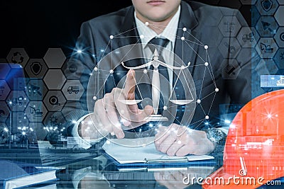 An engineer operating with juridical scales and financial system Stock Photo