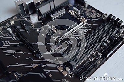 Engineer plugging CPU microprocessor to motherboard socket. Computer technology hardware maintenance or repair. Electronics Stock Photo
