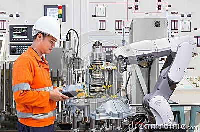 Engineer programing robotic industry in automotive industry Stock Photo