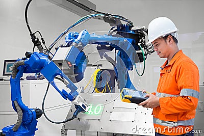 Engineer programming control laser robotic cutting on metal plate, Industry 4.0 concept Stock Photo