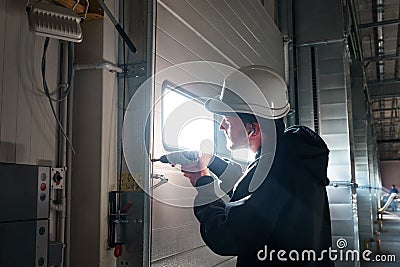 Engineer repairing an unloading gate Stock Photo