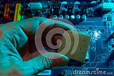 Engineer repairman holding chip CPU to insert into the socket of computer motherboard. Concept of technology hardware Stock Photo