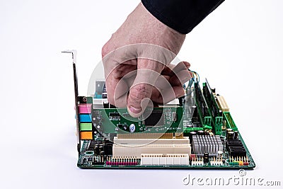 Engineer repairman holding hands in black gloves chip processor, CPU to insert into the socket of the computer motherboard. The Stock Photo