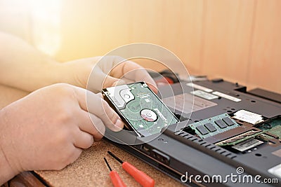 Engineer restores the laptop PC. Installing the hard drive hardware, RAM. Electronic repair shop, technology renovation Stock Photo