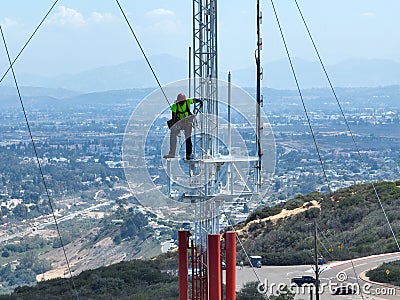 Engineer with safety equipment on high tower for working telecom communication maintenance. Editorial Stock Photo