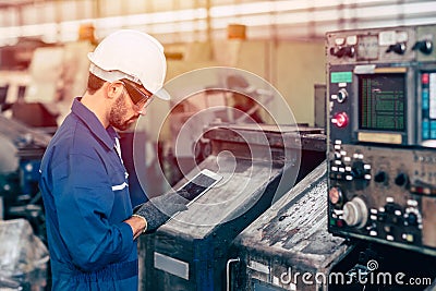Engineer setup the CNC machine with G-Code programming upload from Computer Tablet for technology in heavy industry Stock Photo