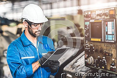 Engineer setup the CNC machine with G-Code programming upload from Computer Tablet for technology in heavy industry Stock Photo