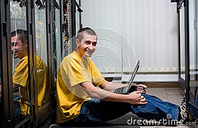 The engineer sits in datacenter Stock Photo