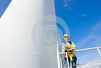 Engineer smart professional techician woman working service wind turbine sustainable eco power energy genrator from nature Stock Photo