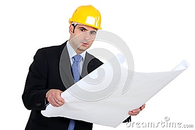 Engineer studying plans Stock Photo