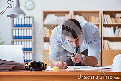 The engineer supervisor working on drawings in the office Stock Photo