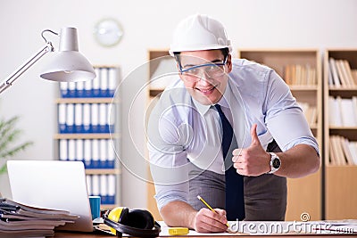 The engineer supervisor working on drawings in the office Stock Photo