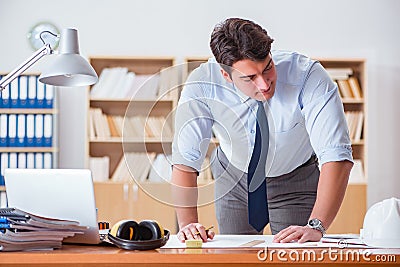 The engineer supervisor working on drawings in the office Stock Photo