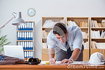 The engineer supervisor working on drawings in the office Stock Photo