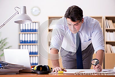 The engineer supervisor working on drawings in the office Stock Photo