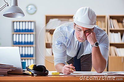 The engineer supervisor working on drawings in the office Stock Photo