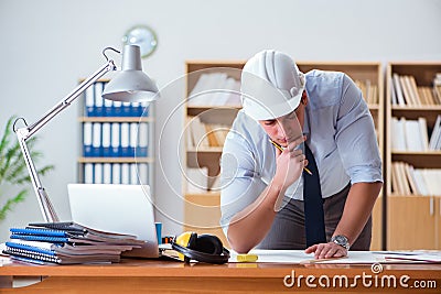 The engineer supervisor working on drawings in the office Stock Photo