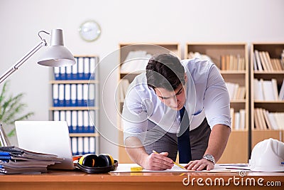 The engineer supervisor working on drawings in the office Stock Photo