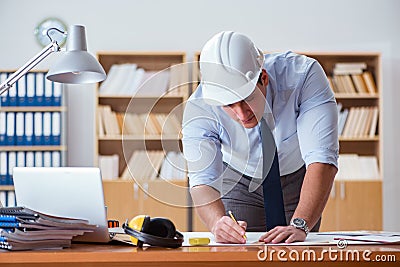 The engineer supervisor working on drawings in the office Stock Photo