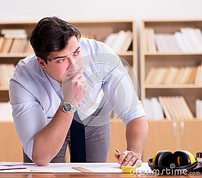 Engineer supervisor working on drawings in the office Stock Photo