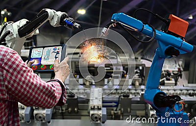 Engineer tablet control the production of factory parts manufacturing industry robots Stock Photo