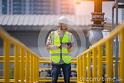 Engineer take water from wastewater treatment pond to check the quality of the water. After going through the wastewater treatmen Stock Photo