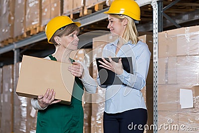 Engineer talking with storage worker Stock Photo