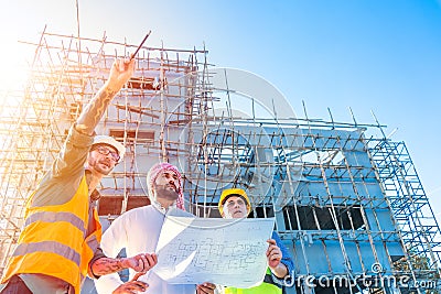 Engineer team group with Arab business estate project manager check floor plan of building at construction site Stock Photo