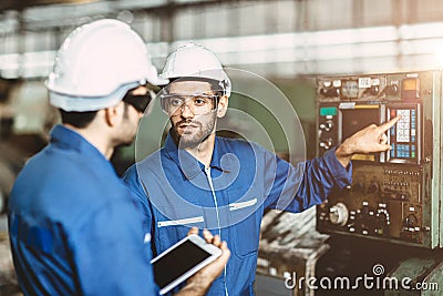 Engineer team talking together to discussion teach and learn give education technical about using machine in factory workplace Stock Photo