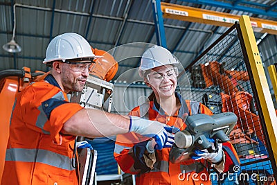 engineer team worker working program robot arm assembly machine in modern metal heavy industry factory Stock Photo