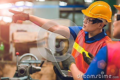 Engineer team working together in heavy industry with laptop computer discussion ordering worker join engineer teamwork Stock Photo