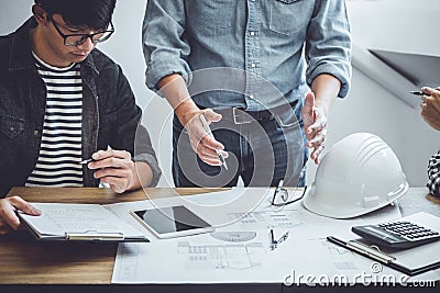 Engineer Teamwork Meeting, Drawing working on blueprint meeting for project working with partner on model building and engineering Stock Photo