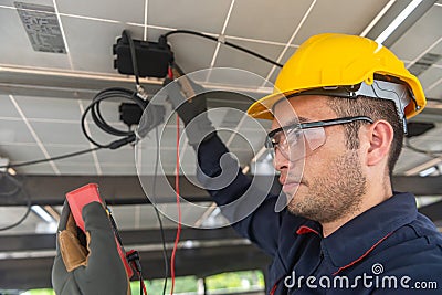 Engineer technical service checking solar panel with electricity meter for check the voltage, checking the system work properly Stock Photo