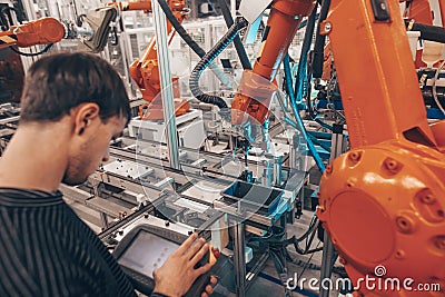 Engineer, technician working with automatic robot in automotive industrial, smart factory, automated workplace Stock Photo