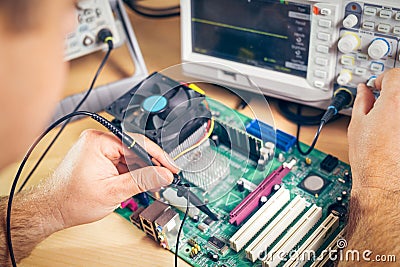 Engineer tests electronic components with oscilloscope in the service center Stock Photo