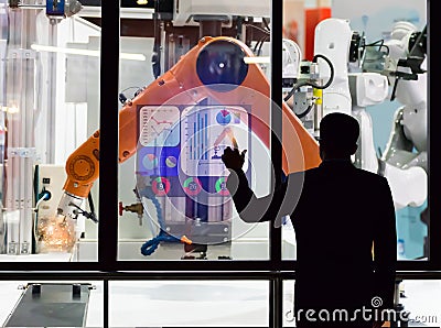 Engineer touch screen control the production of factory parts manufacturing industry robots Editorial Stock Photo