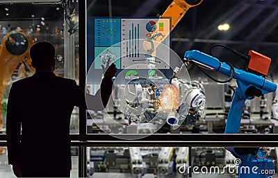 Engineer touch screen control robot the production of factory parts engine manufacturing industry Stock Photo