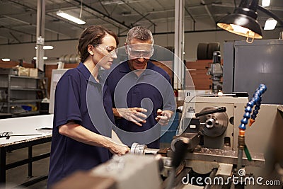 Engineer Training Female Apprentice On Milling Machine Stock Photo