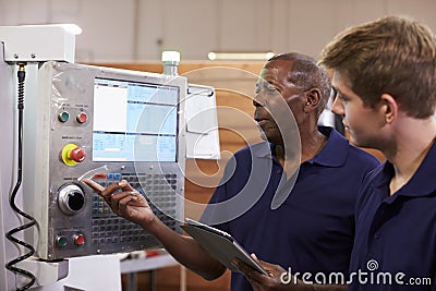 Engineer Training Male Apprentice On CNC Machine Stock Photo