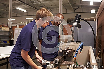 Engineer Training Male Apprentice On Milling Machine Stock Photo