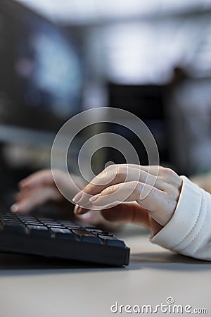 Close up of employee in server farm configuring and testing hardware Stock Photo