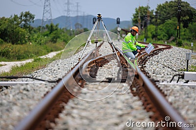 Engineer use theodolite equipment surveying construction worker on Railway site Stock Photo