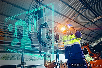 Engineer use VR virtual reality technology control operate robot machine in modern factory new innovation in engineering industry Stock Photo