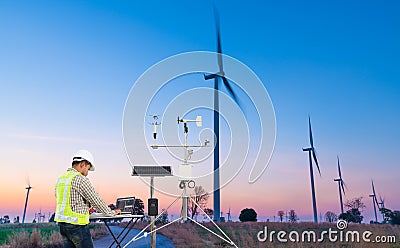 Engineer using laptop computer collect data with meteorological instrument to measure the wind speed, temperature and humidity and Stock Photo