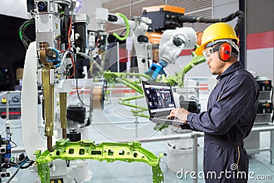 Engineer using laptop computer maintenance automatic robotic han Stock Photo