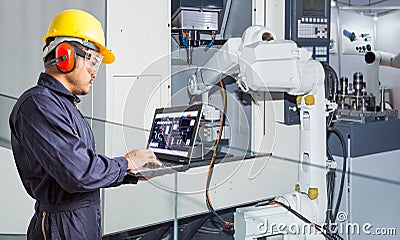 Engineer using laptop computer for maintenance automatic robotic Stock Photo